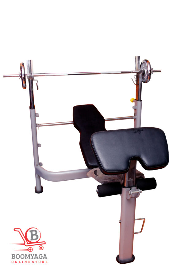 Commercial wheel bench with barbell rack, preacher curl pad, and leg extension attachment for professional strength training and gym workouts.